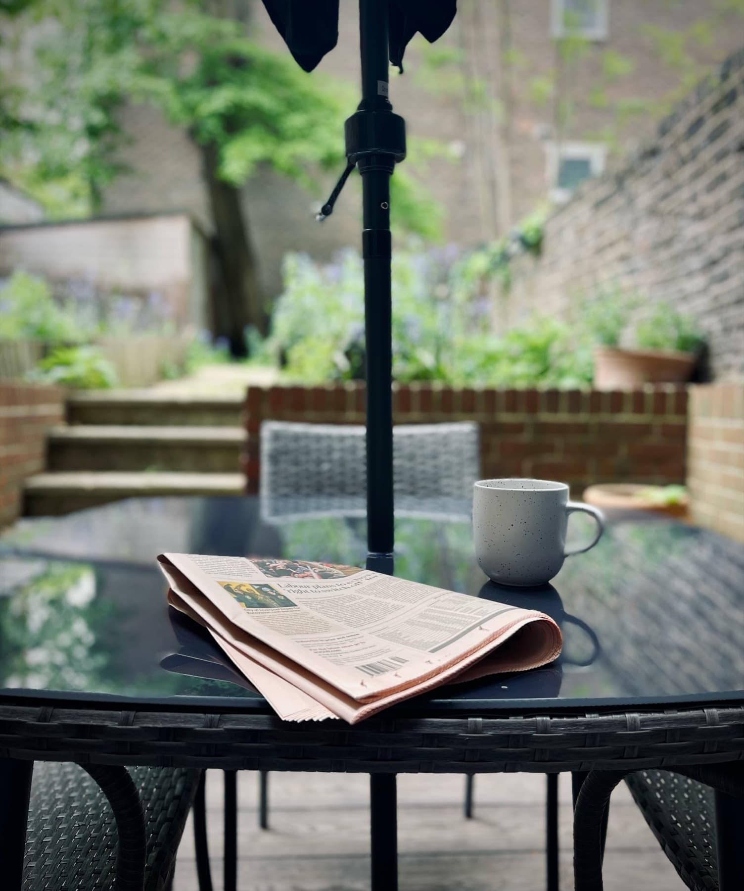 Morning coffee and a newspaper on the courtyard bistro table